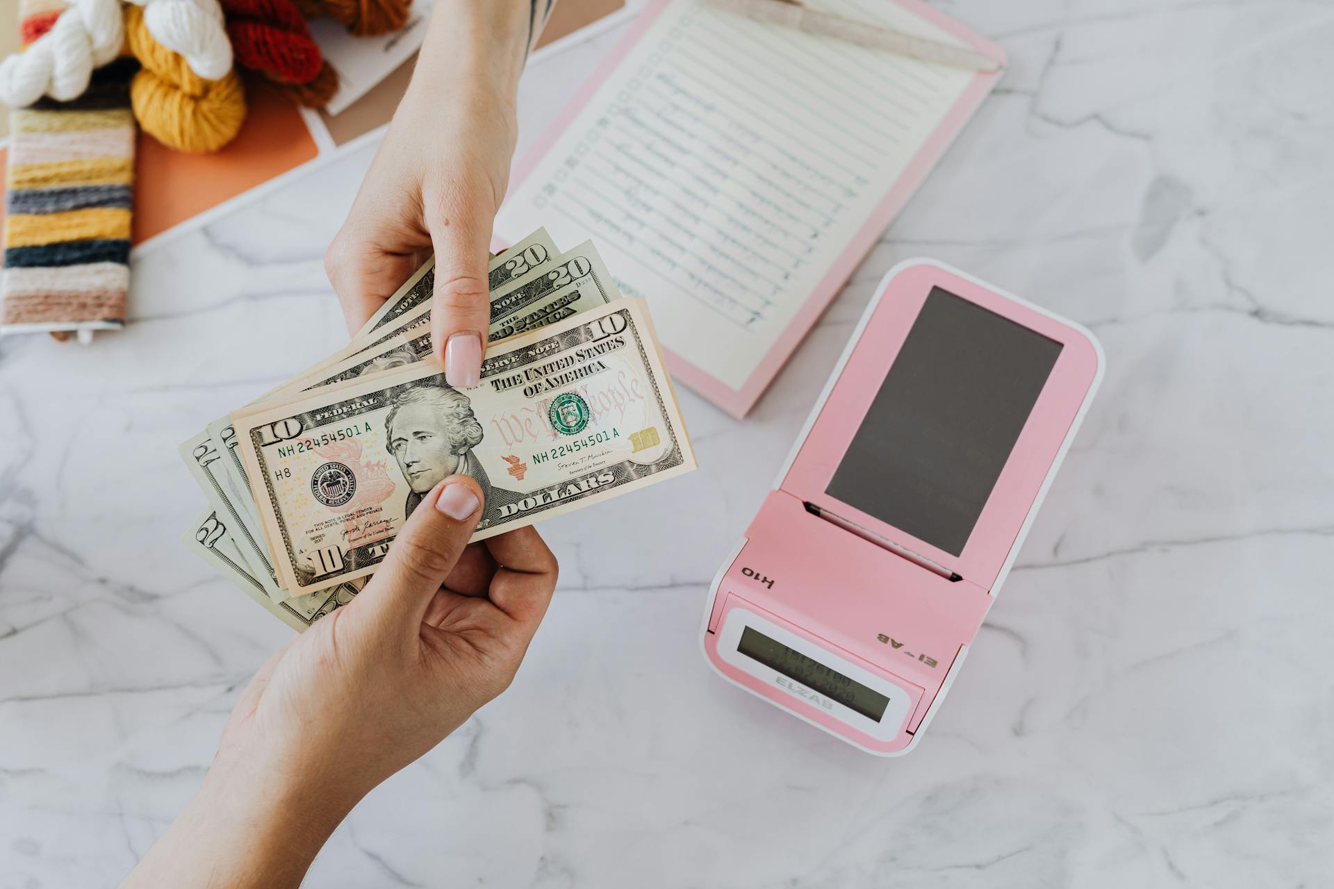 cash transaction between two people over a pos system