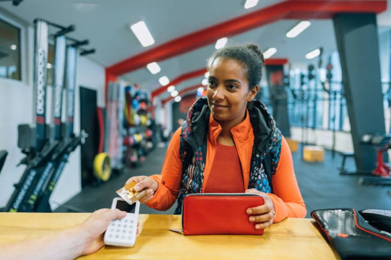 woman using payments solutions at a small gym